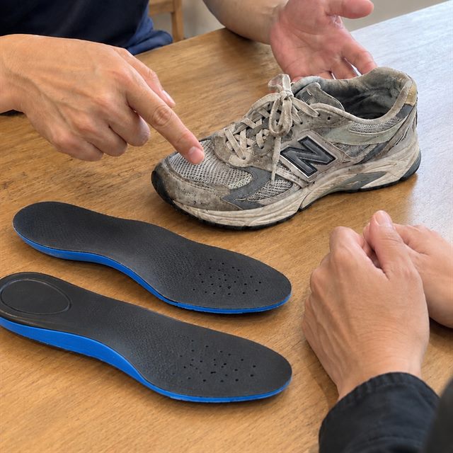 テーブルに置いた靴を指さしながら相談しているところ